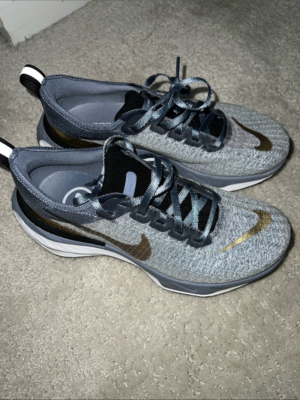 Nike Light Blue Knit Sneakers with Gold Swoosh